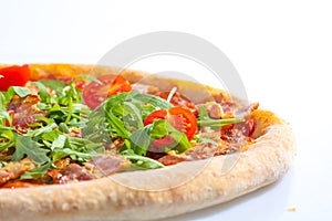 Italian hot pizza with tomato, arugula and pieces of bÐ°Ñon isolated on white background